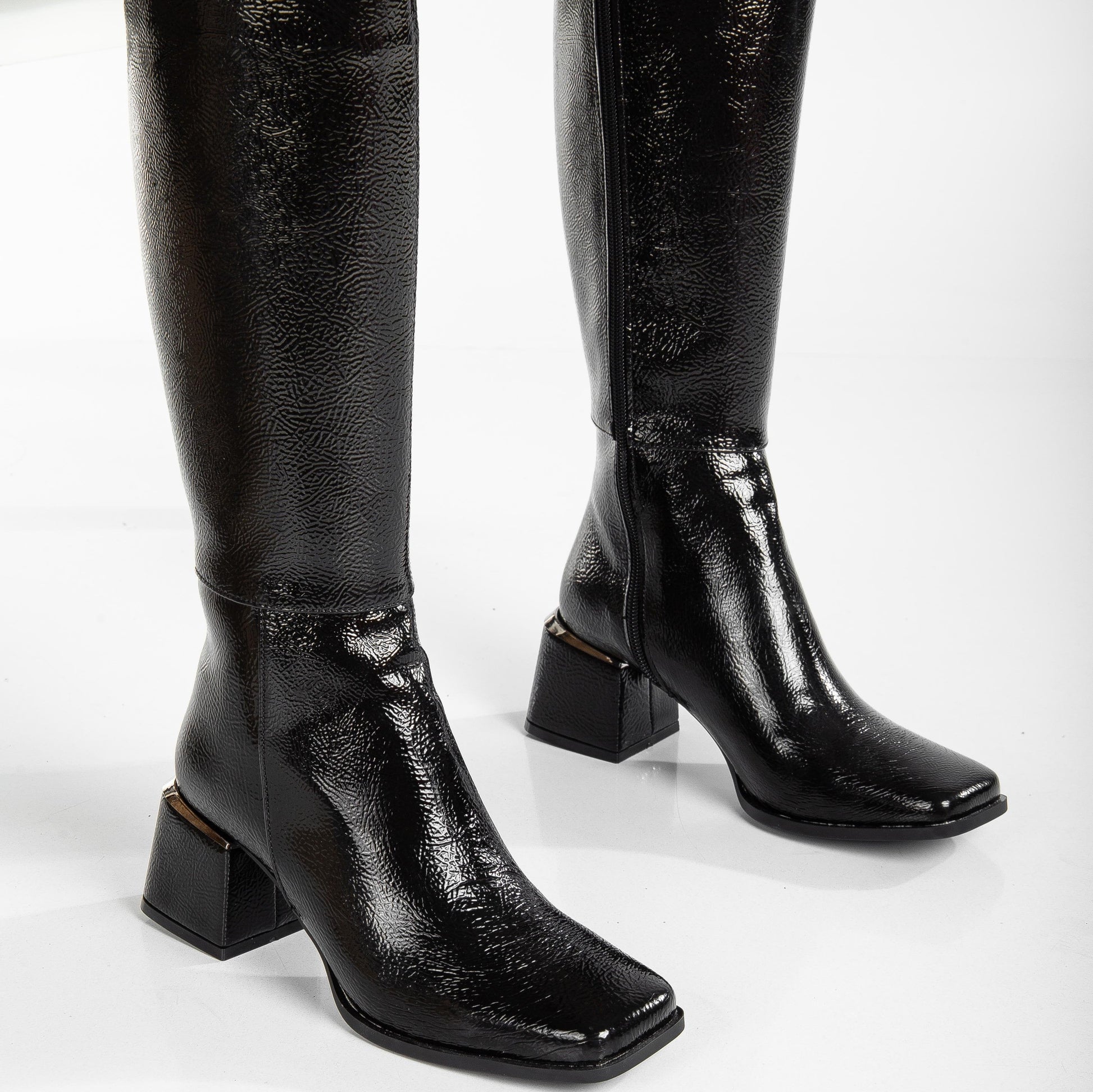 vegan black patent boots, black knee high boots, cruelty-free footwear, eco-friendly fashion, sustainable boots, plant-based patent leather, black vegan boots, non-leather boots, animal-free footwear, ethical fashion, vegan heeled boots, glossy black boots, stylish knee high boots, high heel boots, vegan patent boots, women's vegan footwear