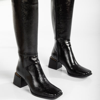 vegan black patent boots, black knee high boots, cruelty-free footwear, eco-friendly fashion, sustainable boots, plant-based patent leather, black vegan boots, non-leather boots, animal-free footwear, ethical fashion, vegan heeled boots, glossy black boots, stylish knee high boots, high heel boots, vegan patent boots, women's vegan footwear
