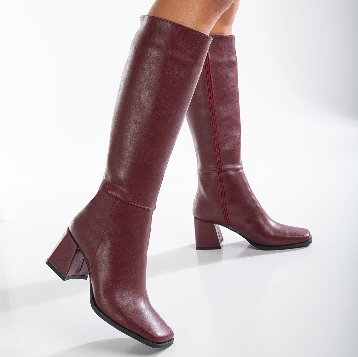 Vegan knee-high boots, black knee-high boots, burgundy knee-high boots, sustainable knee-high boots, cruelty-free knee-high boots, eco-friendly knee-high boots, vegan leather knee-high boots, women's knee-high boots, stylish knee-high boots, faux leather knee-high boots.