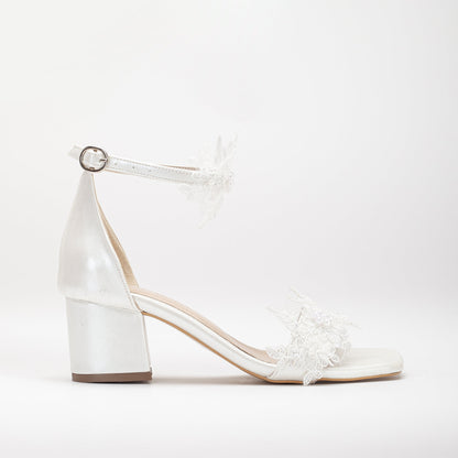 Ivory white shoes with lace on the front, Lace-front ivory white shoes, Ivory white footwear featuring front lace detail, Shoes in ivory white with lace detailing on the front, Front-laced ivory white shoes, Ivory white shoes adorned with lace on the front, Lace-accented ivory white shoes, Ivory white shoes with front lace design, Front lace ivory white footwear, Ivory white shoes with lace embellishment on the front.