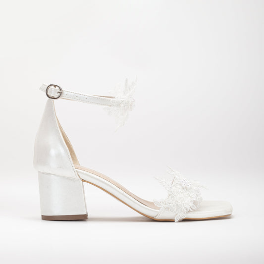 Ivory white shoes with lace on the front, Lace-front ivory white shoes, Ivory white footwear featuring front lace detail, Shoes in ivory white with lace detailing on the front, Front-laced ivory white shoes, Ivory white shoes adorned with lace on the front, Lace-accented ivory white shoes, Ivory white shoes with front lace design, Front lace ivory white footwear, Ivory white shoes with lace embellishment on the front.